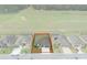 Aerial view of the property with a spacious backyard bordering an open field, surrounded by neighboring homes at 9773 Sw 63Rd Loop, Ocala, FL 34481