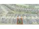 Aerial view of a home nestled in a neighborhood featuring lush green spaces and a tranquil pond at 9773 Sw 63Rd Loop, Ocala, FL 34481
