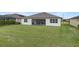 The home features a large backyard with a screened-in porch and a white painted exterior at 9773 Sw 63Rd Loop, Ocala, FL 34481