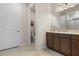 Bright bathroom with a double sink, wooden cabinets, and a separate toilet room at 9773 Sw 63Rd Loop, Ocala, FL 34481