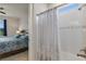 Bright bathroom with a shower-tub combination and view to a beautifully decorated bedroom at 9773 Sw 63Rd Loop, Ocala, FL 34481