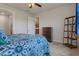 Cozy bedroom with a view to the kitchen, featuring a comfortable bed, dresser and a decorative shelf at 9773 Sw 63Rd Loop, Ocala, FL 34481
