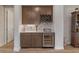 Elegant butler's pantry featuring custom cabinetry, wine rack, and under-counter wine refrigerator at 9773 Sw 63Rd Loop, Ocala, FL 34481