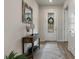 Entryway with decorative mirror, table and decorated door with a view to additional areas at 9773 Sw 63Rd Loop, Ocala, FL 34481