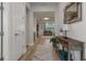 Inviting foyer with wood-look flooring, stylish console table, leading to the living area with neutral tones at 9773 Sw 63Rd Loop, Ocala, FL 34481