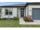 Charming home featuring a welcoming front door with a decorative wreath and a well-maintained lawn at 9773 Sw 63Rd Loop, Ocala, FL 34481