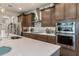 Modern kitchen featuring stainless steel appliances, backsplash, large island with seating, and custom cabinetry at 9773 Sw 63Rd Loop, Ocala, FL 34481
