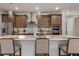 Well-appointed kitchen featuring a spacious island with seating, stylish pendant lighting, and stainless steel appliances at 9773 Sw 63Rd Loop, Ocala, FL 34481