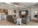 Open-concept living space featuring comfortable seating, entertainment center, and kitchen with breakfast bar at 9773 Sw 63Rd Loop, Ocala, FL 34481