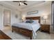 This main bedroom offers tray ceilings, a large window, bedside tables, and an ensuite bath at 9773 Sw 63Rd Loop, Ocala, FL 34481