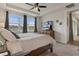 This main bedroom offers a large window with outdoor view, ceiling fan, and TV over dresser at 9773 Sw 63Rd Loop, Ocala, FL 34481