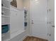 Functional mudroom with built-in storage, bench, and coat hooks at 9773 Sw 63Rd Loop, Ocala, FL 34481