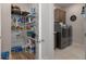 Pantry with wire shelving located off laundry room with front loading washer and dryer at 9773 Sw 63Rd Loop, Ocala, FL 34481