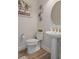 Nicely decorated powder room featuring a modern sink, toilet, and neutral wall color at 9773 Sw 63Rd Loop, Ocala, FL 34481