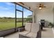 This screened porch features outdoor furniture, ceiling fan, and a grill overlooking green backyard at 9773 Sw 63Rd Loop, Ocala, FL 34481