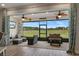 Relax on this home's screened porch with fan and furniture overlooking lush green lawn at 9773 Sw 63Rd Loop, Ocala, FL 34481