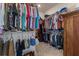 A large walk-in closet with clothing racks, shelves, carpeted floor and a chest on the right at 9773 Sw 63Rd Loop, Ocala, FL 34481