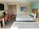 Nicely decorated hotel bedroom, featuring desk, storage, and stylish beds at 3000 Maingate Ln # 420, Kissimmee, FL 34747