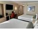 Comfortable hotel bedroom with two beds, a desk, a flat screen TV, and modern decor at 3000 Maingate Ln # 420, Kissimmee, FL 34747