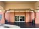 Hotel entrance featuring automatic sliding doors, columns, and exterior lighting at 3000 Maingate Ln # 420, Kissimmee, FL 34747