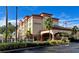 The Galleria Inn is a peach and red three-story building with palm trees at 3000 Maingate Ln # 420, Kissimmee, FL 34747