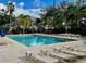 Relaxing pool area with lounge chairs and lush tropical landscaping at 3000 Maingate Ln # 420, Kissimmee, FL 34747