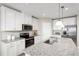 Modern kitchen features granite countertops, stainless steel appliances, and white cabinets at 1262 Whispering Ln, Minneola, FL 34715