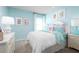 Charming bedroom with light blue walls, whimsical decor, and a comfortable bed perfect for a restful night's sleep at 1306 Whispering Ln, Minneola, FL 34715