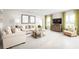 Bright living room with neutral tones, stylish furnishings, and large windows that fills the space with natural light at 1306 Whispering Ln, Minneola, FL 34715