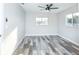 Bright bedroom with stylish flooring, ceiling fan, and natural light at 17975 Se 106Th Ct, Summerfield, FL 34491