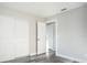 Bedroom with gray wood flooring and ample closet space at 17975 Se 106Th Ct, Summerfield, FL 34491