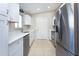 Updated kitchen with stainless steel appliances, quartz countertops, white cabinets, and tile flooring at 17975 Se 106Th Ct, Summerfield, FL 34491