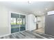 Bright kitchen featuring stainless steel appliances, white cabinetry, and an adjacent dining area with sliding doors at 17975 Se 106Th Ct, Summerfield, FL 34491