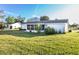 Single story home with a screened porch and manicured lawn at 17975 Se 106Th Ct, Summerfield, FL 34491