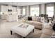 Open-concept living room with modern furnishings adjacent to the bright kitchen area at 7325 Sw 108Th St, Ocala, FL 34476