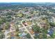 Aerial view of a property nestled in a lush, green neighborhood with scattered homes and trees at 12 Almond Ter, Ocala, FL 34472