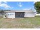 Backyard view of home featuring a screened in porch and lots of yard space at 12 Almond Ter, Ocala, FL 34472