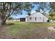 Expansive backyard view with mature trees and a glimpse of the home's screened-in porch at 12 Almond Ter, Ocala, FL 34472