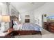 Inviting bedroom with a dark wood bed frame, soft lighting, and a connected bathroom at 12 Almond Ter, Ocala, FL 34472