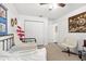 Bright bedroom shows closet, daybed, and a chair with a decorative wall hanging and art at 12 Almond Ter, Ocala, FL 34472