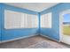 Bright bonus room with blue walls, wood floors, and lots of light from two large windows at 12 Almond Ter, Ocala, FL 34472