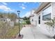Charming exterior view featuring a well-maintained concrete patio and a fenced yard with attractive landscape lighting at 12 Almond Ter, Ocala, FL 34472