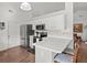 Bright kitchen with white cabinets, stainless steel appliances, and a breakfast bar for casual dining at 12 Almond Ter, Ocala, FL 34472