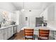 Well-lit kitchen with white cabinets, modern appliances, breakfast bar and wood-look flooring at 12 Almond Ter, Ocala, FL 34472