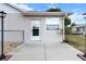 Back of home shows a patio, door, window, lights and partial fence at 12 Almond Ter, Ocala, FL 34472