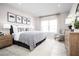 Comfortable bedroom with a large window, soft decor and detailed decorations at 1314 Whispering Ln, Minneola, FL 34715