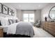Bright bedroom featuring neutral tones, large window and decorative artwork at 1314 Whispering Ln, Minneola, FL 34715