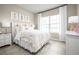 Bright bedroom with large window, patterned bedding and soft decorations at 1314 Whispering Ln, Minneola, FL 34715