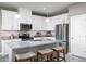 Stylish kitchen features stainless steel appliances, granite countertops and bar stool seating at 1314 Whispering Ln, Minneola, FL 34715