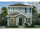 Charming two-story home with a covered entry, black shutters, and lush tropical landscaping at 3828 Denali Dr, Apopka, FL 32712